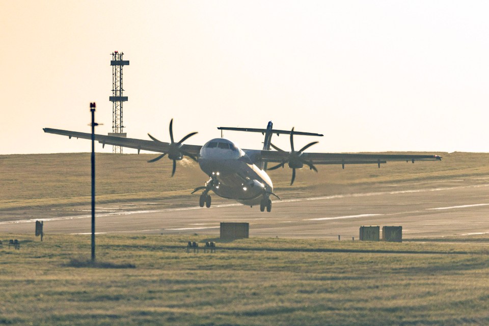 A Flybe aircraft is blown sideways in the 40mph winds as it departs Leeds Bradford Airport this morning