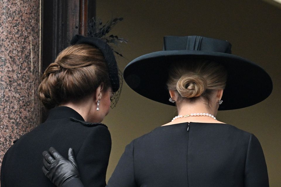 Sophie placed a hand on Kate's back as they left the balcony