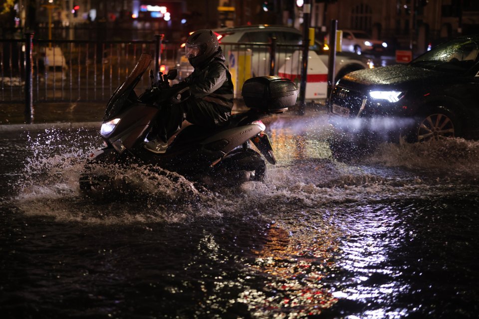 Vehicles make a splash as they are driven through deep surface water