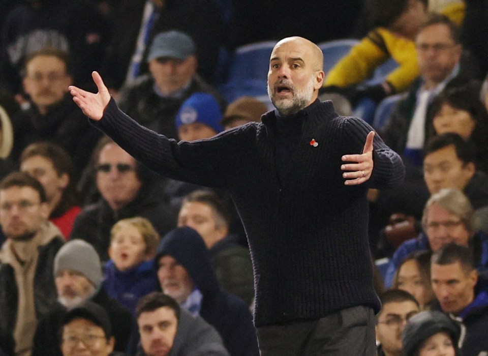 a man in a black sweater with a red heart on it stands in front of a crowd