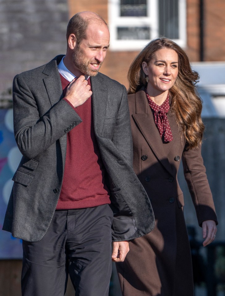 a bald man and a woman are walking together