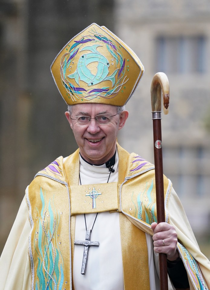 a man wearing a hat with a cross on it