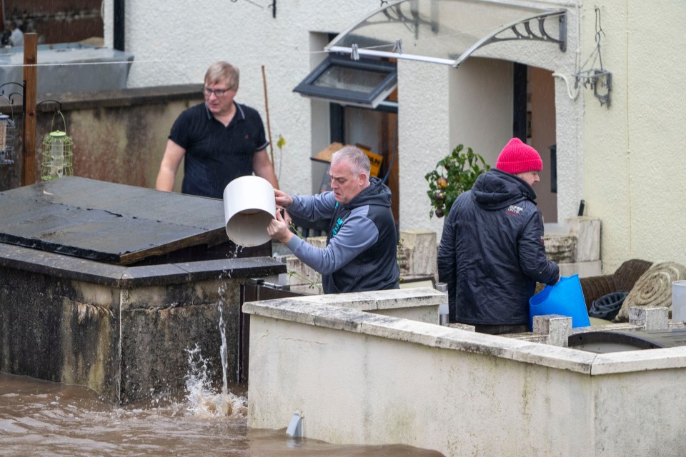 Locals are pouring water out of their front gardens using buckets