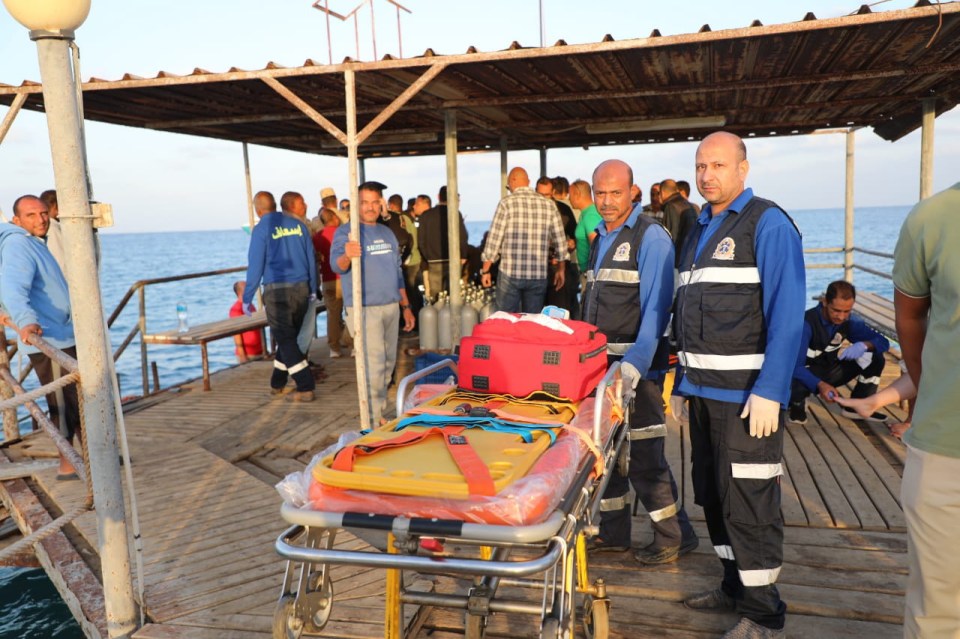 Medics on the pier helping survivors from the sinking