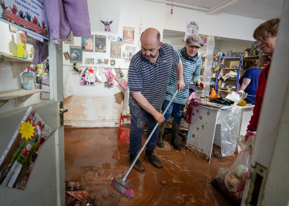 Locals gather together to help businesses clear out after the storm in Worcestershire