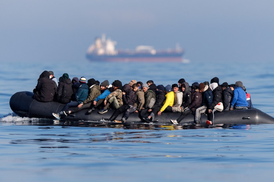 A boat carrying migrants make the dangerous journey across the Channel