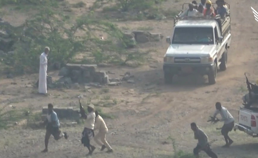 a group of people are running towards a toyota truck