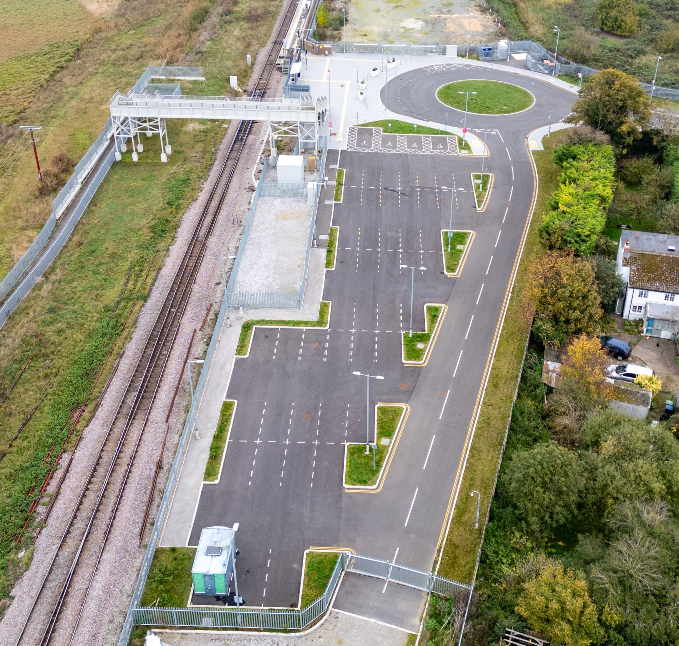 an aerial view of a parking lot next to a train track