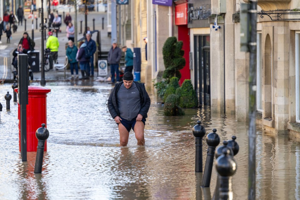 A man braved the water in centre of Chippenham in Wiltshire