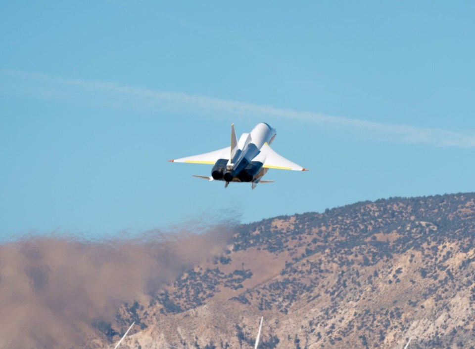 a fighter jet is flying over a mountain range