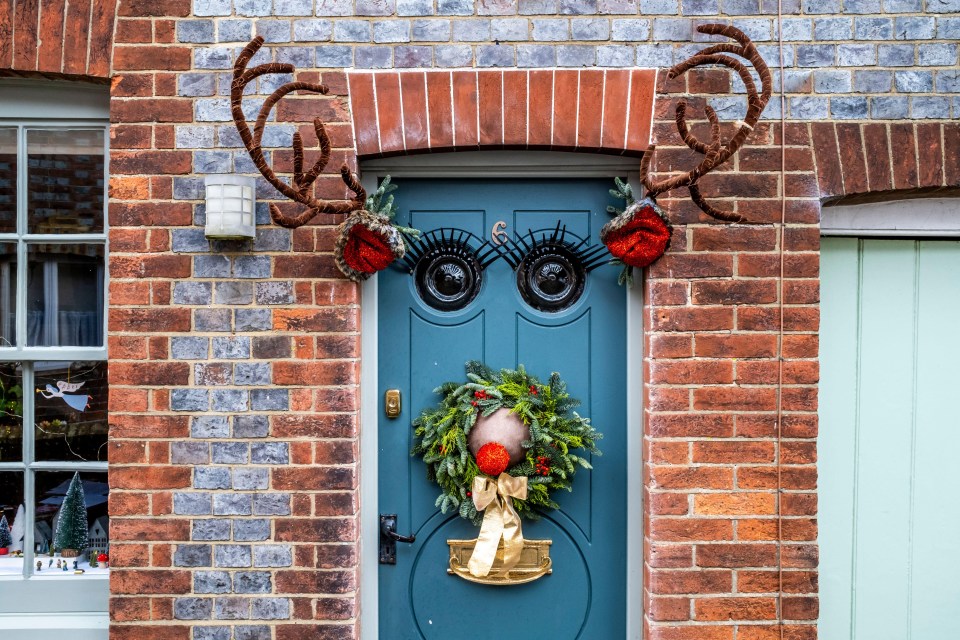 2X0JM4Y Christmas Decorations In The Shape of A Reindeer On A House Front Door At Christmas Time, Lewes, East Sussex, UK.