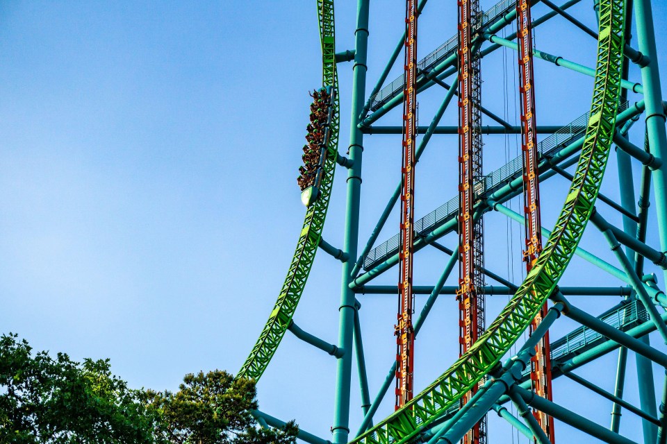 a roller coaster with a blue sky in the background