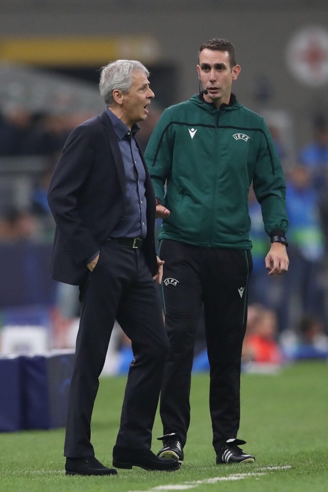 a man in a green jacket with the word uefa on it