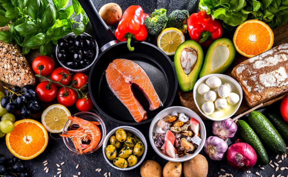 a variety of fruits and vegetables are laid out on a table