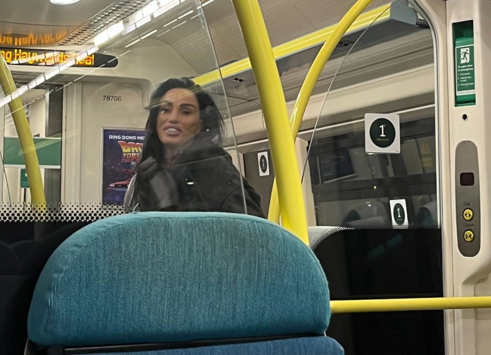 a woman sits on a bus with a sign that says ' ambulance ' on it