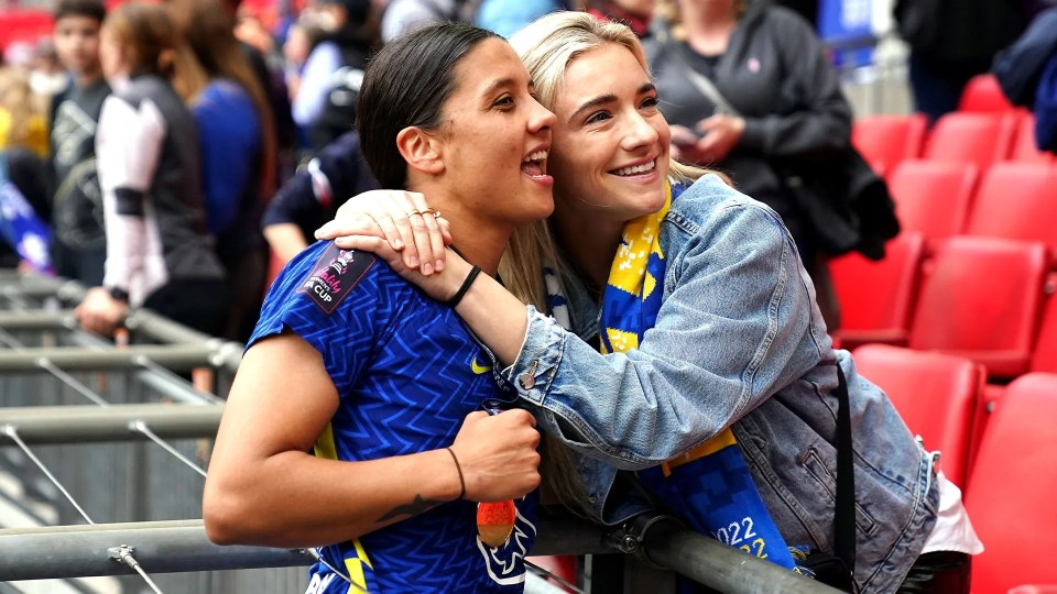 two women are hugging and one has a shirt that says 2022 on it