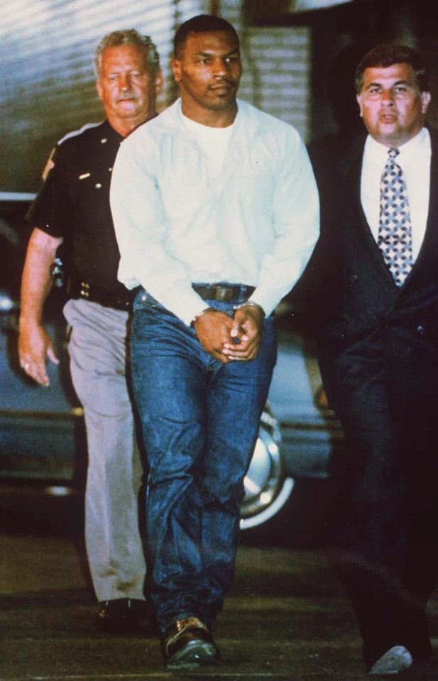 Mike Tyson being led away by cops after rape arrest in 1991