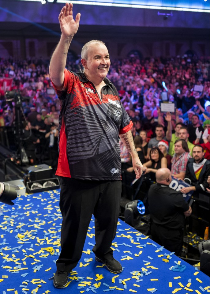 Phil 'The Power' Taylor gestures to his supporters