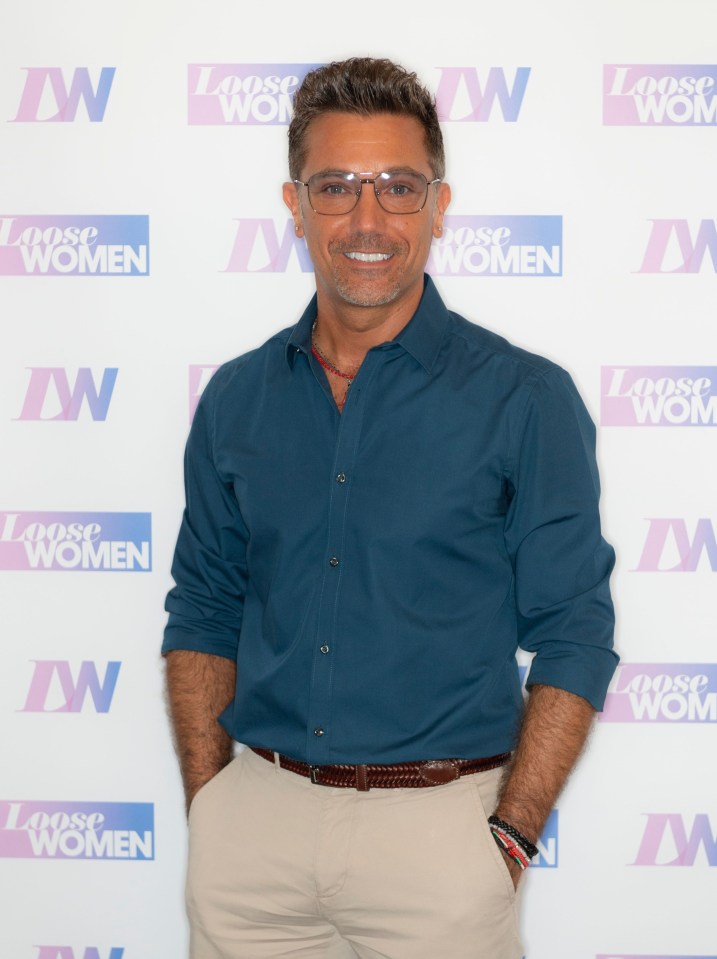 a man stands in front of a wall that says loose women