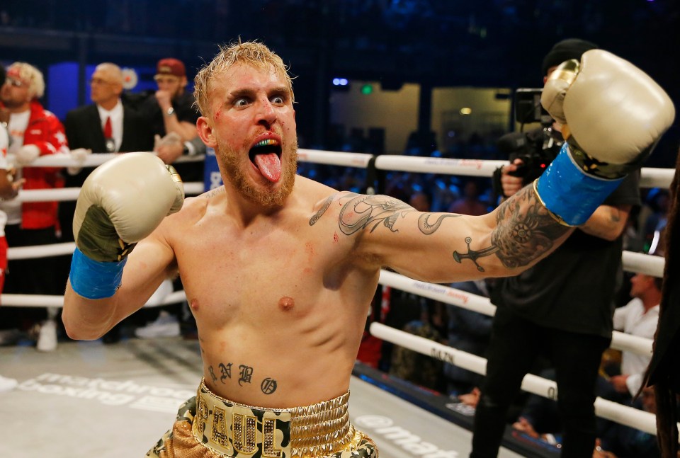 a man in a boxing ring with his tongue out