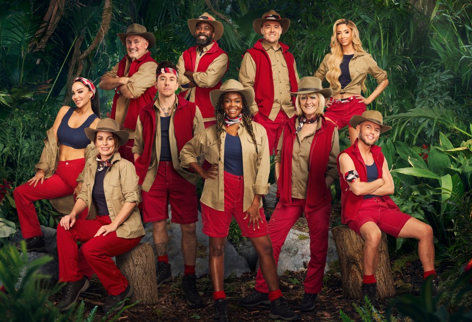 a group of people posing for a picture in the jungle