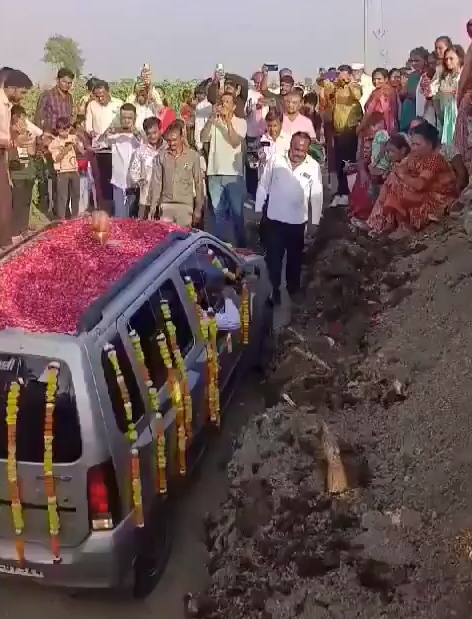 The car is slowly backed into the 15ft grave as an audience of 1,500 look on