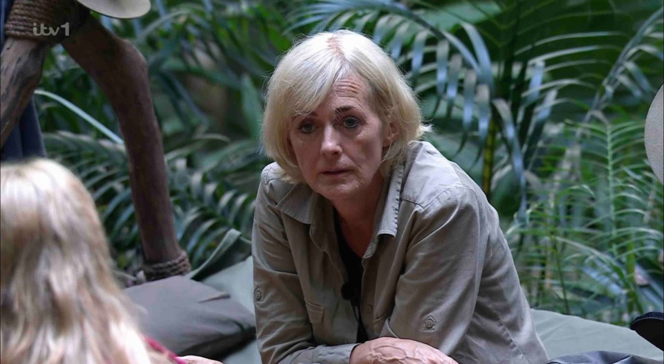 a woman sits on a couch in the jungle with itv 1 written on the bottom