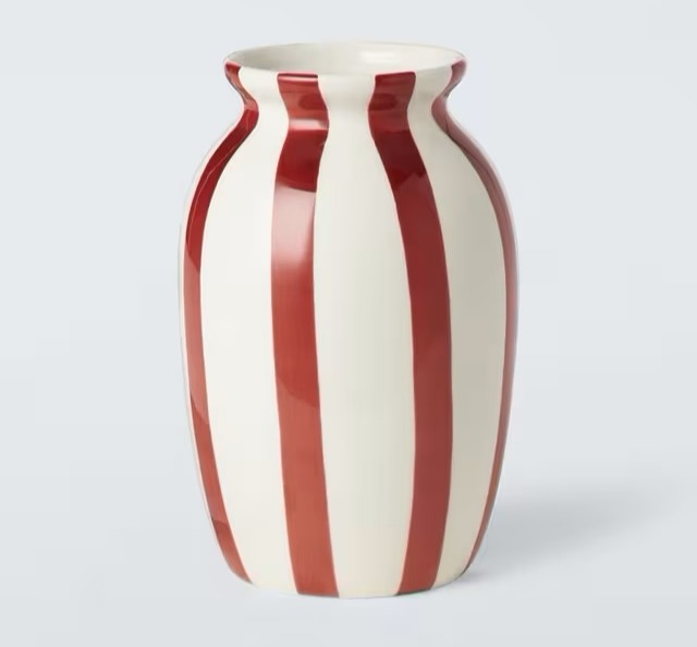 a red and white striped vase on a white background