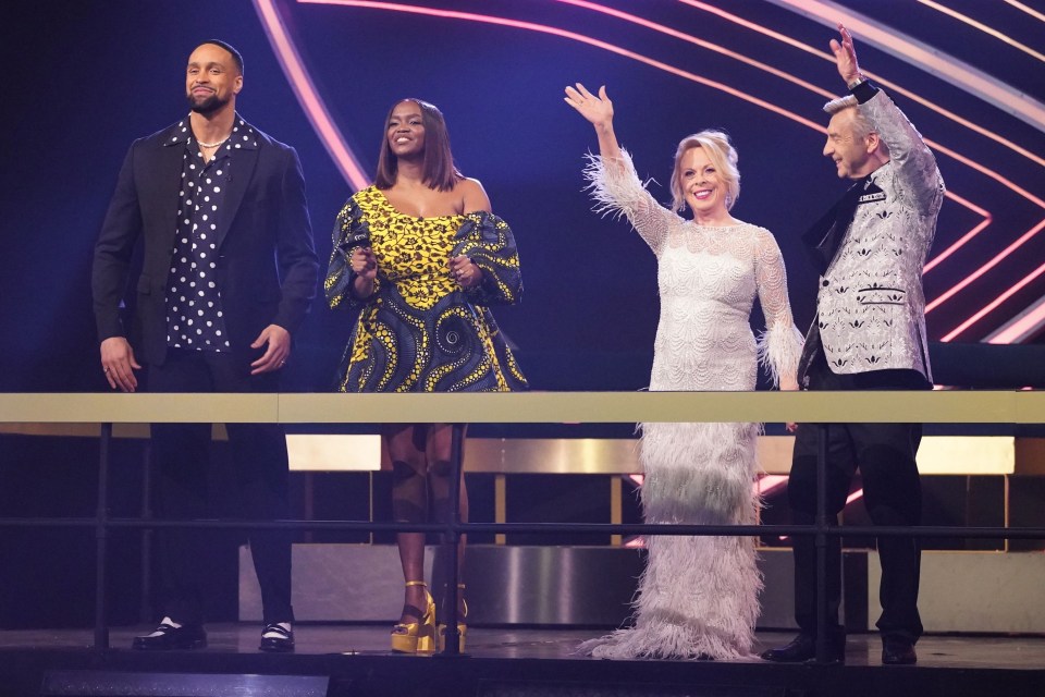 a group of people standing on a stage waving