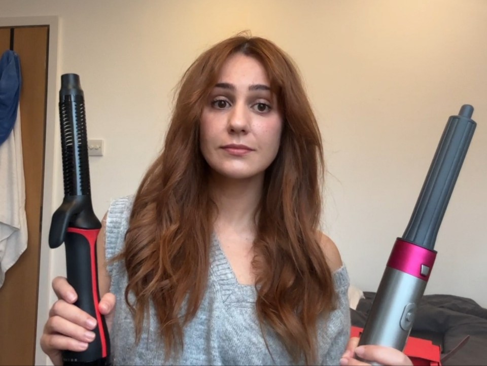 a woman with red hair is holding two hair curlers in her hands