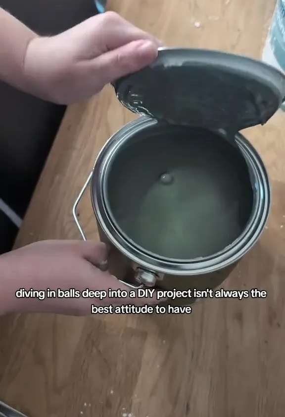 a person is holding a can of paint that says diving in balls deep into a diy project