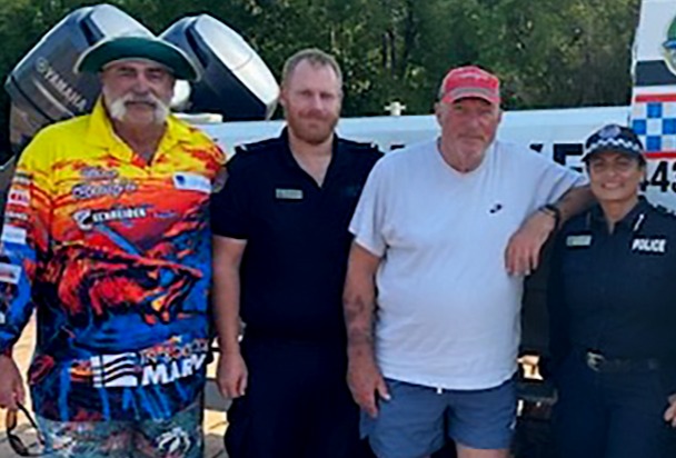 Brit cricket legend Ian Botham, second from right, and former Aussie rival Merv Hughes, with cops after the rescue