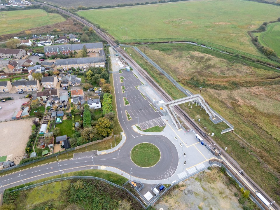 an aerial view of a road with a roundabout in the middle