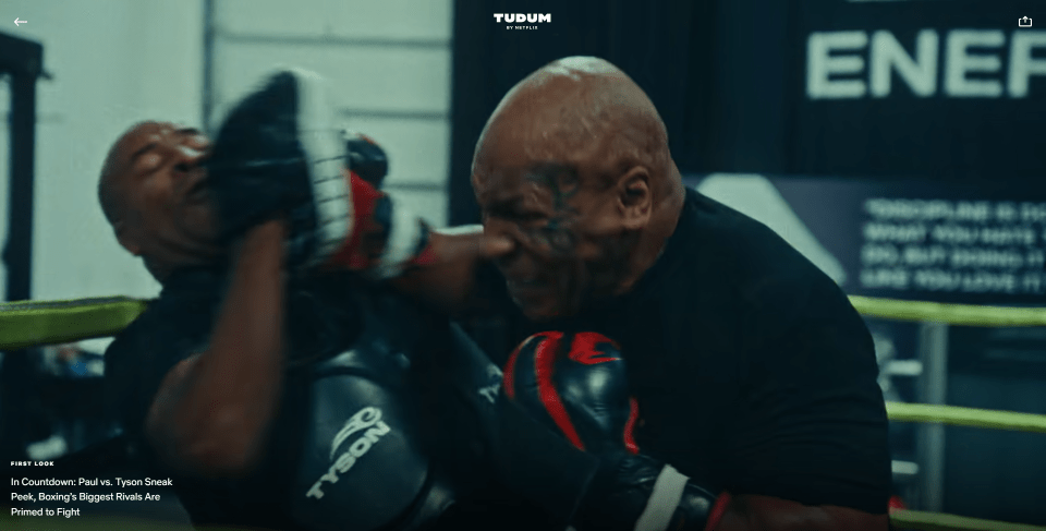 Head trainer Rafael Cordeiro holds the pads for Tyson