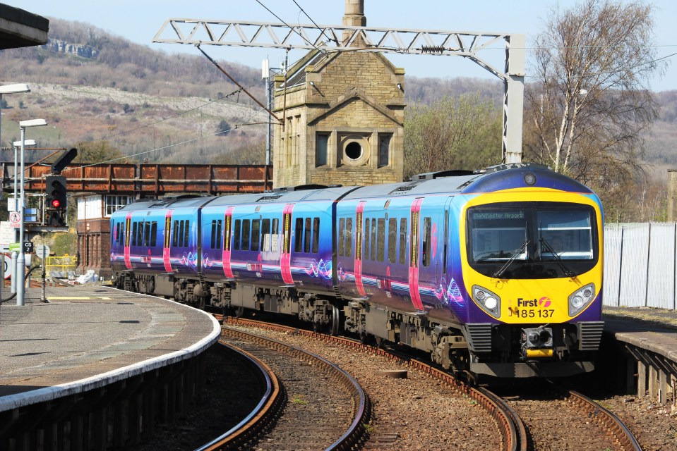 a blue and yellow train that says first on the front