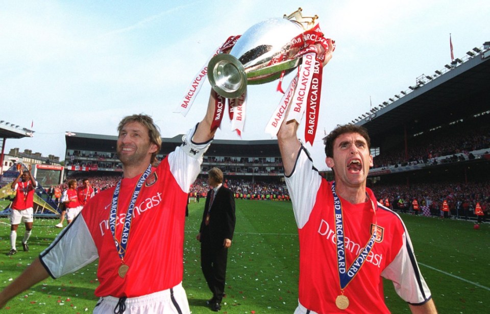 LONDON, ENGLAND - MAY 11: Tony Adams and Martin Keown of Arsenal with the Premier League trophy after the match between Arsenal and Everton on May 11, 2002 in London, England. (Photo by Stuart MacFarlane/Arsenal FC via Getty Images)