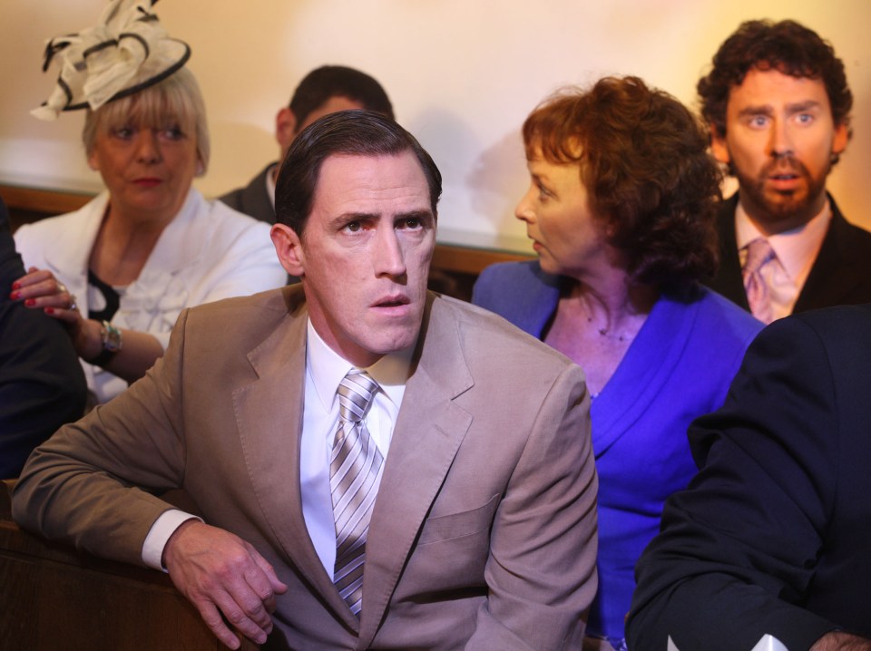 a man in a suit and tie sits in a church with other people