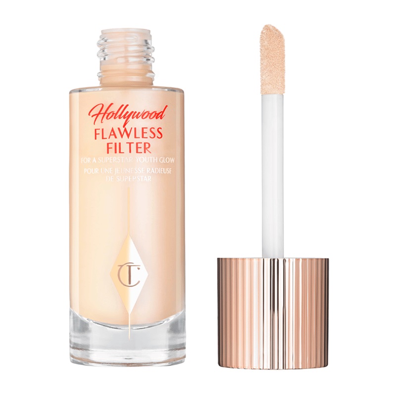 a bottle of hollywood flawless filter next to a brush