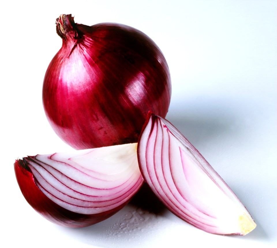 a red onion is cut in half on a white surface