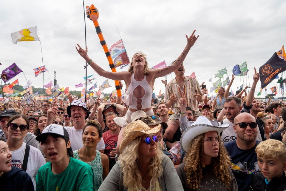 a crowd of people at a festival with a flag that says ' jägermeister ' on it