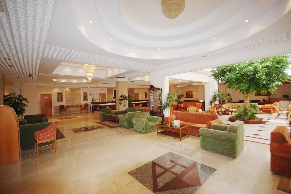 a hotel lobby with a tree in the middle