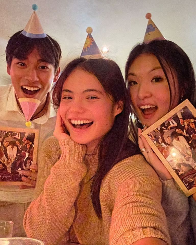 three people wearing party hats are posing for a picture