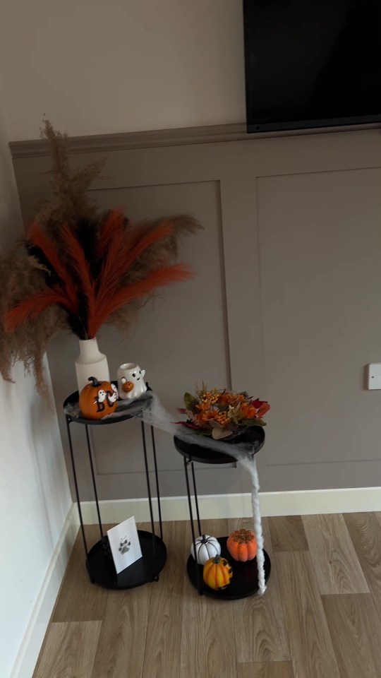 two small tables with halloween decorations on them