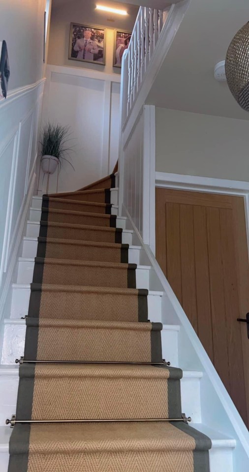 a staircase with a carpet on the bottom steps