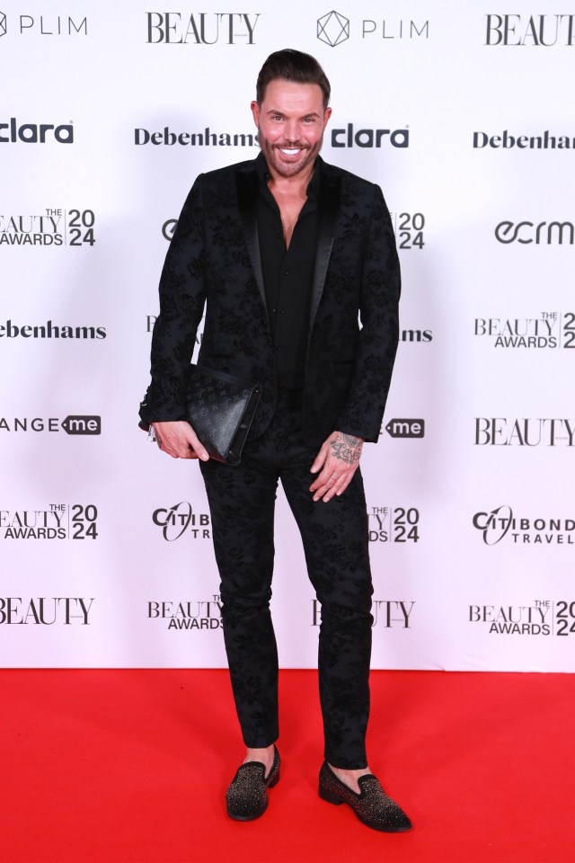 Radio presenter Bobby Norris looked suave in a black velvet blazer as he carried a Louis Vuitton bag