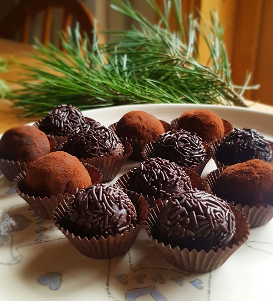 a white plate topped with chocolate truffles and sprinkles