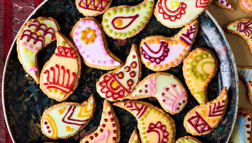 a plate of decorated cookies with paisley designs on them