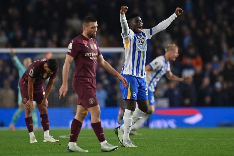 Brighton's Cameroonian midfielder #20 Carlos Baleba (2R) celebrates on the pitch after the English Premier League football match between Brighton and Hove Albion and Manchester City at the American Express Community Stadium in Brighton, southern England on November 9, 2024. Brighton won the game 2-1. (Photo by Glyn KIRK / AFP) / RESTRICTED TO EDITORIAL USE. No use with unauthorized audio, video, data, fixture lists, club/league logos or 'live' services. Online in-match use limited to 120 images. An additional 40 images may be used in extra time. No video emulation. Social media in-match use limited to 120 images. An additional 40 images may be used in extra time. No use in betting publications, games or single club/league/player publications. / (Photo by GLYN KIRK/AFP via Getty Images)