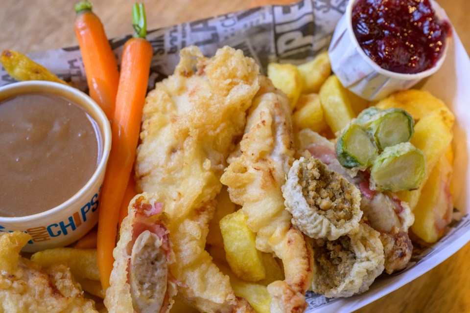 a bowl of chips sits next to a plate of food