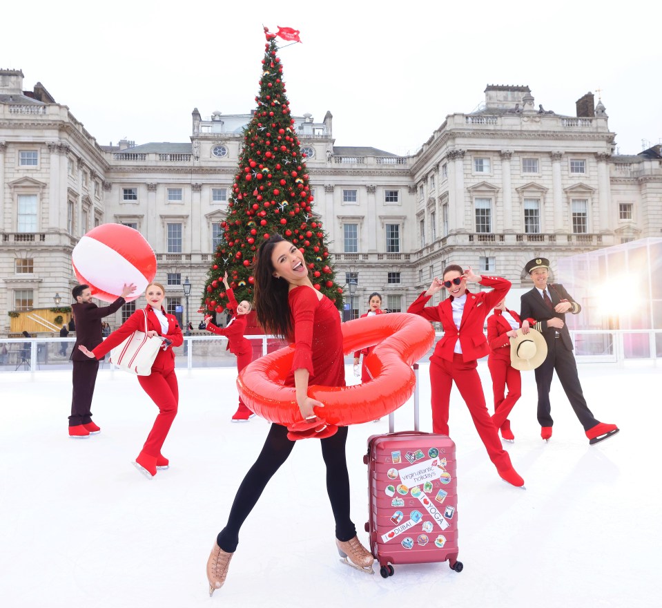 a woman with a red suitcase that says ' christmas ' on it